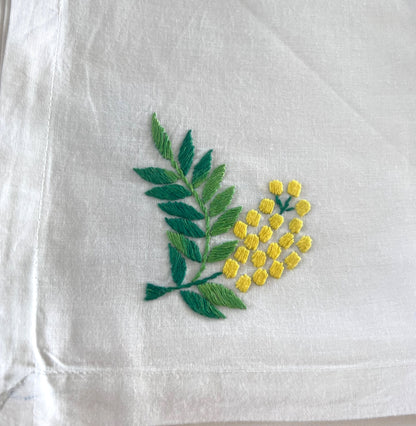 handmade crisp white cotton napkin with yellow embroidery